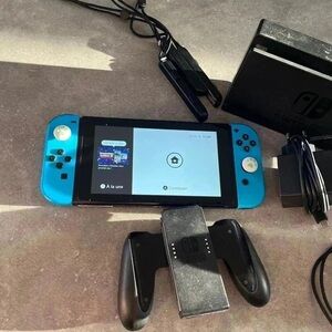 Nintendo Switch with Blue and Black Controllers